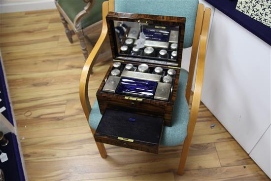 A Victorian brass inlaid rosewood travelling toilet box by Asprey containing ten engine turned silver mounted toilet jars,